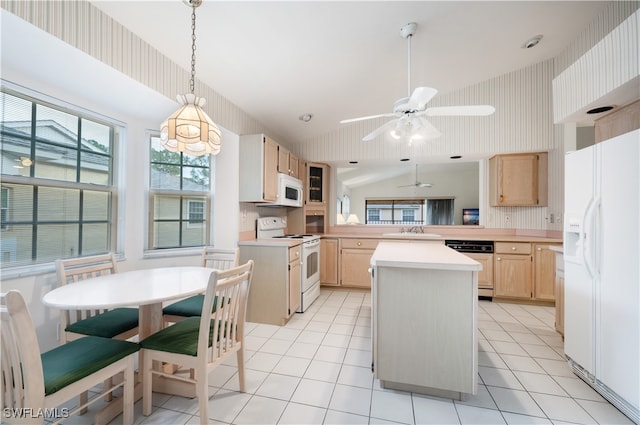 kitchen featuring white appliances, light brown cabinetry, kitchen peninsula, lofted ceiling, and a center island