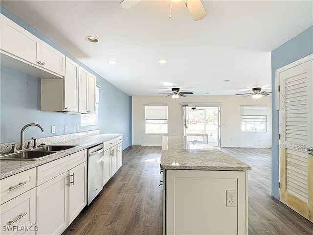 kitchen with dishwasher, a kitchen island, dark hardwood / wood-style floors, sink, and white cabinets