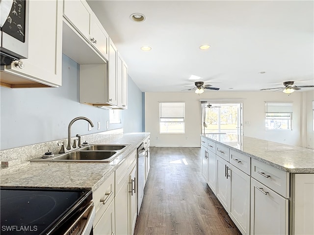 kitchen with range with electric cooktop, dark wood-type flooring, white cabinetry, and sink