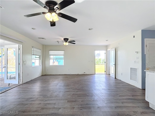 spare room with dark hardwood / wood-style floors and ceiling fan