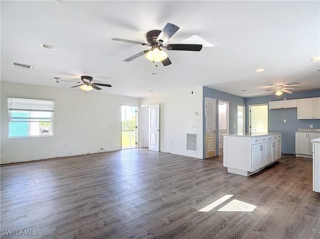 27571 Tarpon Way, Bonita Springs, FL 34134 - unfurnished living room featuring healthy amount of natural light, a ceiling fan, dark wood-type flooring, and recessed lighting