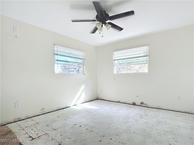 unfurnished room with ceiling fan and plenty of natural light