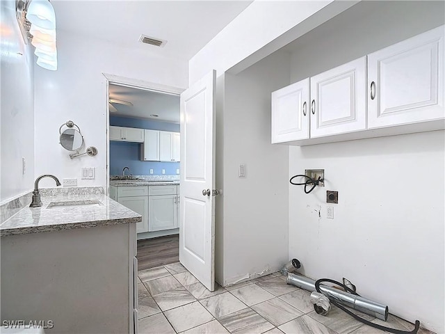 27571 Tarpon Way, Bonita Springs, FL 34134 - laundry area with a ceiling fan and light marble finish flooring