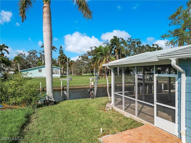 27571 Tarpon Way, Bonita Springs, FL 34134 - view of green lawn featuring a sunroom and a water view