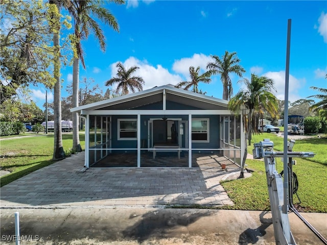 view of front of house featuring a front lawn and a sunroom