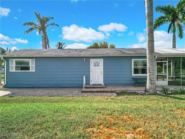 27571 Tarpon Way, Bonita Springs, FL 34134 - ranch-style home featuring a front yard, a sunroom, and a patio area