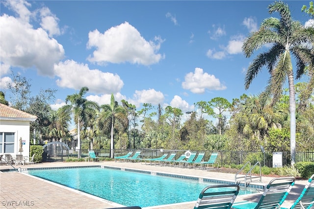 11842 Bayport Ln Unit 2104, Fort Myers, FL 33908 - community pool with a patio area and view of wooded area