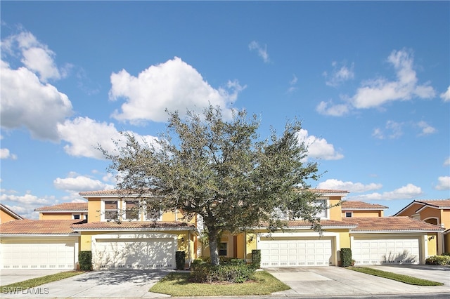 mediterranean / spanish-style home with a garage