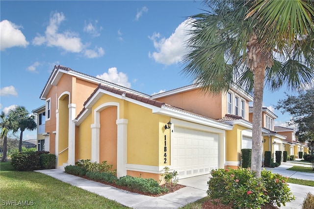 11842 Bayport Ln Unit 2104, Fort Myers, FL 33908 - view of side of property with a tiled roof, stucco siding, a garage, and concrete driveway