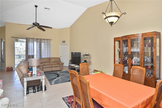 dining space with high vaulted ceiling, light tile patterned flooring, and ceiling fan