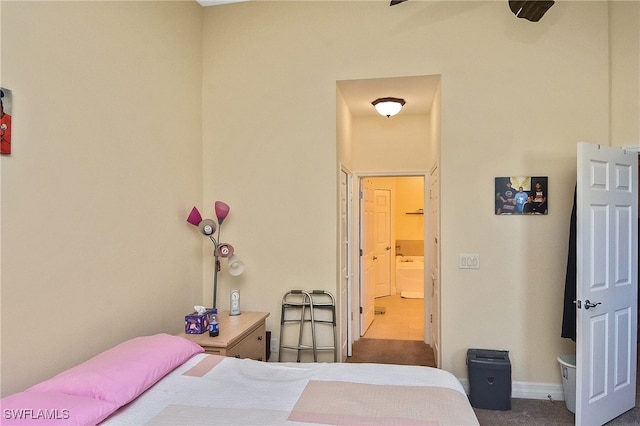 bedroom with carpet, ceiling fan, and connected bathroom