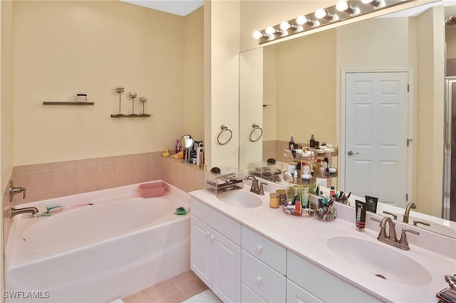 bathroom with vanity, tile patterned floors, and a bathtub