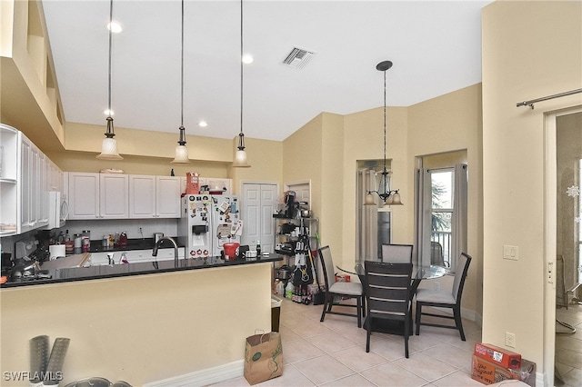 kitchen featuring light tile patterned flooring, white cabinetry, hanging light fixtures, sink, and white appliances