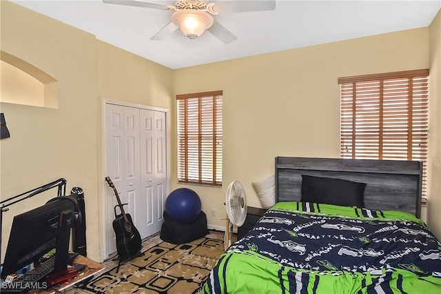 bedroom with a closet, multiple windows, and ceiling fan