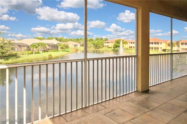 unfurnished sunroom featuring a water view