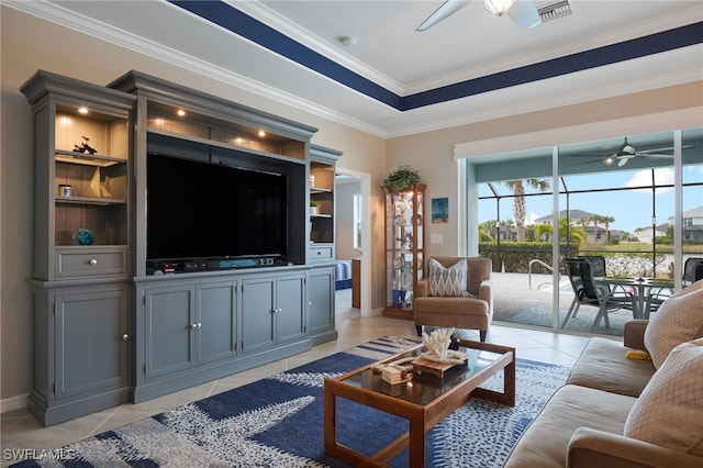 tiled living room with built in shelves, ceiling fan, and crown molding