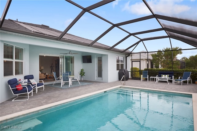 view of swimming pool with a lanai, ceiling fan, and a patio area