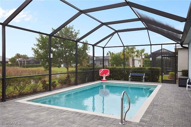 view of pool with a patio and a lanai