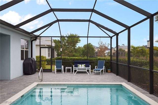 view of pool featuring a lanai, a grill, and a patio