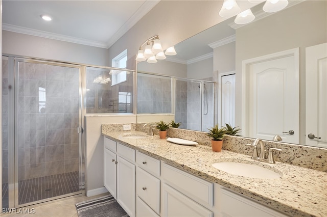 bathroom with ornamental molding, vanity, tile patterned flooring, a chandelier, and a shower with shower door