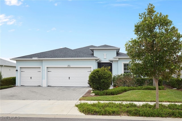 prairie-style home with a garage and a front yard