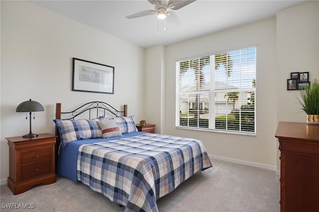 bedroom with light carpet and ceiling fan