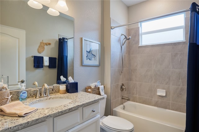 full bathroom featuring vanity, shower / bath combination with curtain, and toilet