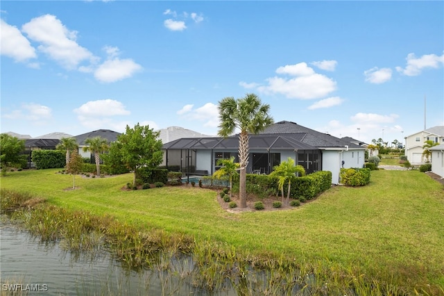 back of house featuring a lawn, a lanai, and a water view