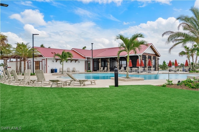 view of pool featuring a yard and a patio area