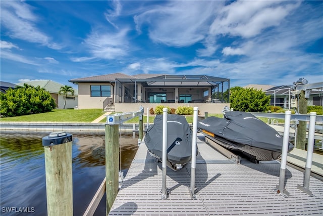 exterior space with a lanai and a water view