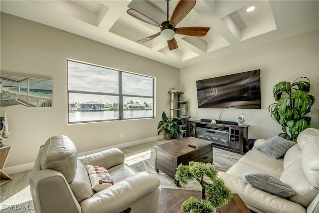 living room featuring ceiling fan, coffered ceiling, beamed ceiling, and light hardwood / wood-style flooring