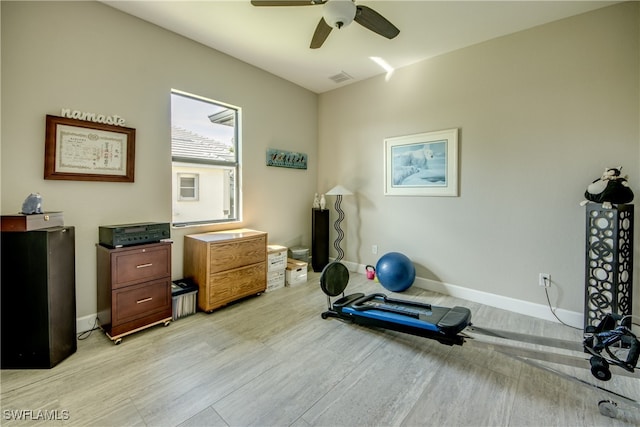 workout area with light wood-type flooring and ceiling fan