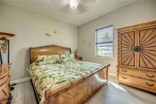 bedroom with light hardwood / wood-style floors and ceiling fan