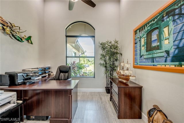 office featuring light hardwood / wood-style floors and ceiling fan