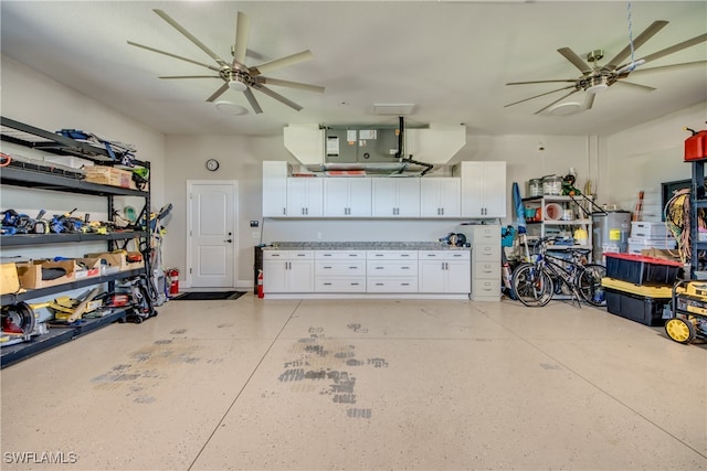 garage with water heater and ceiling fan