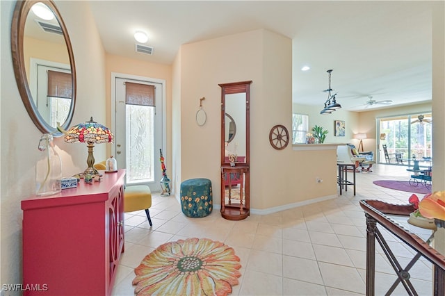 entryway featuring ceiling fan and light tile patterned floors