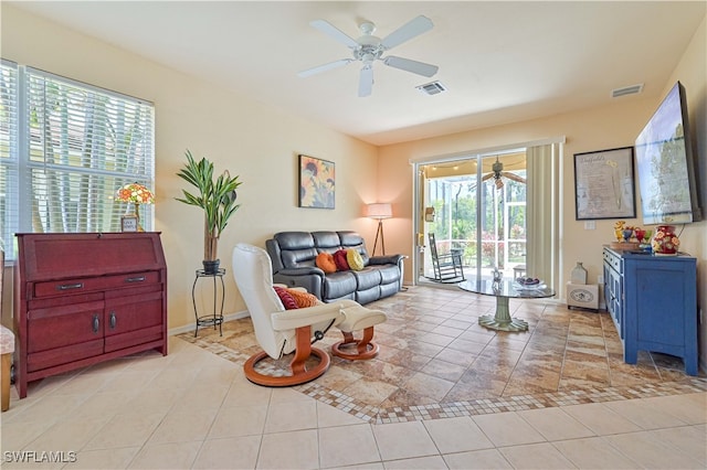 tiled living room featuring ceiling fan