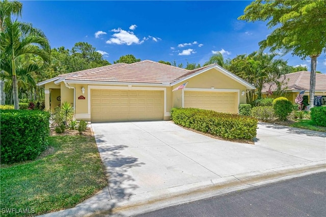 ranch-style house with a garage, a tiled roof, concrete driveway, and stucco siding