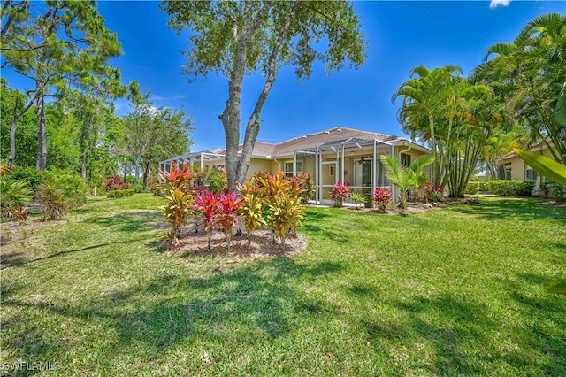 view of yard with a lanai