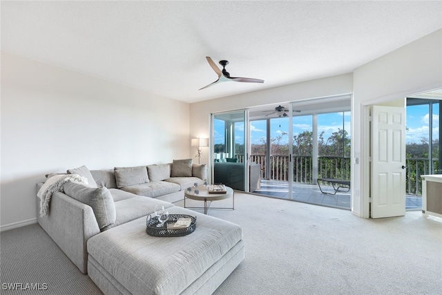 carpeted living room with ceiling fan