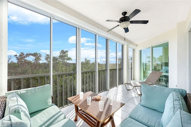 sunroom / solarium featuring ceiling fan