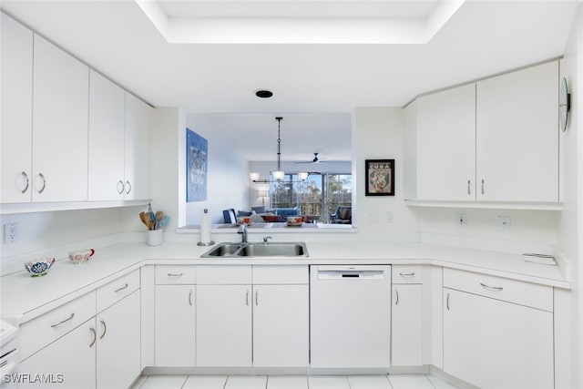 kitchen featuring dishwasher, white cabinets, light tile patterned floors, and sink