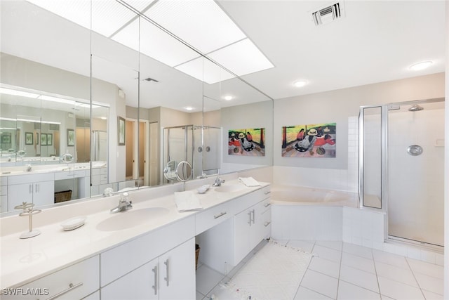 bathroom featuring tile patterned flooring, vanity, and independent shower and bath