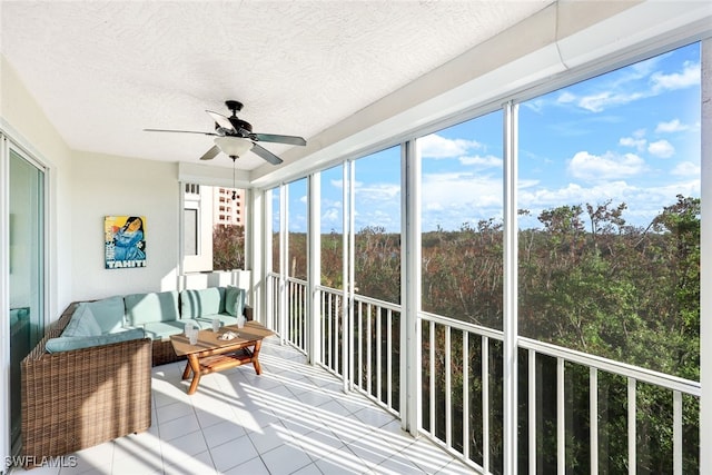 sunroom / solarium featuring ceiling fan