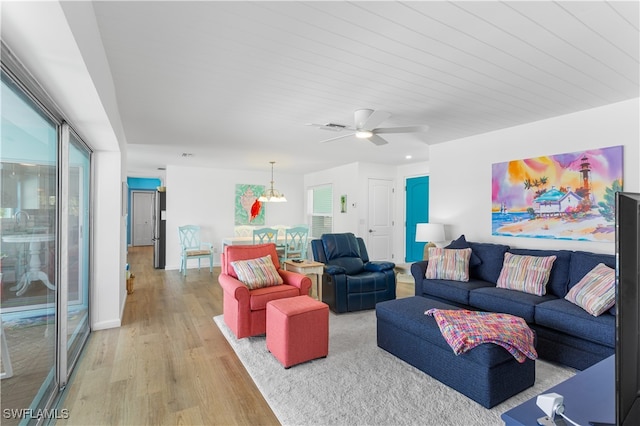 living room with hardwood / wood-style floors and ceiling fan