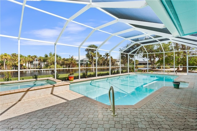 view of pool with a water view, glass enclosure, an in ground hot tub, and a patio area