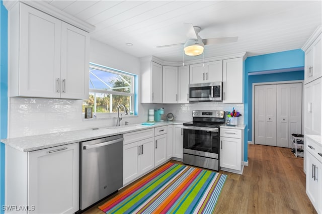 kitchen featuring light hardwood / wood-style flooring, white cabinets, sink, and stainless steel appliances