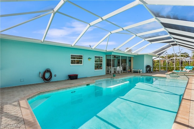 view of pool featuring a patio area, a grill, a lanai, and ceiling fan