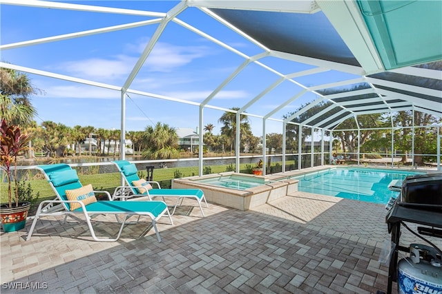 view of swimming pool with a lanai, a patio, and an in ground hot tub