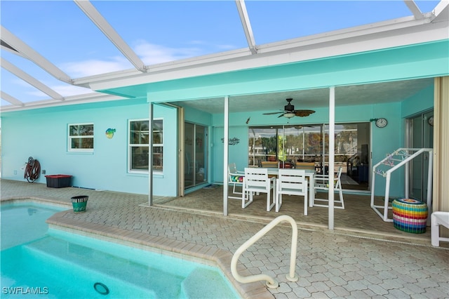 view of pool featuring ceiling fan, a lanai, and a patio area